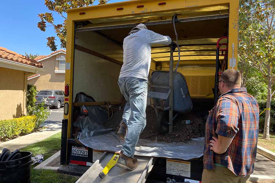 A Jedi Junk Removal crew loading material into a truck