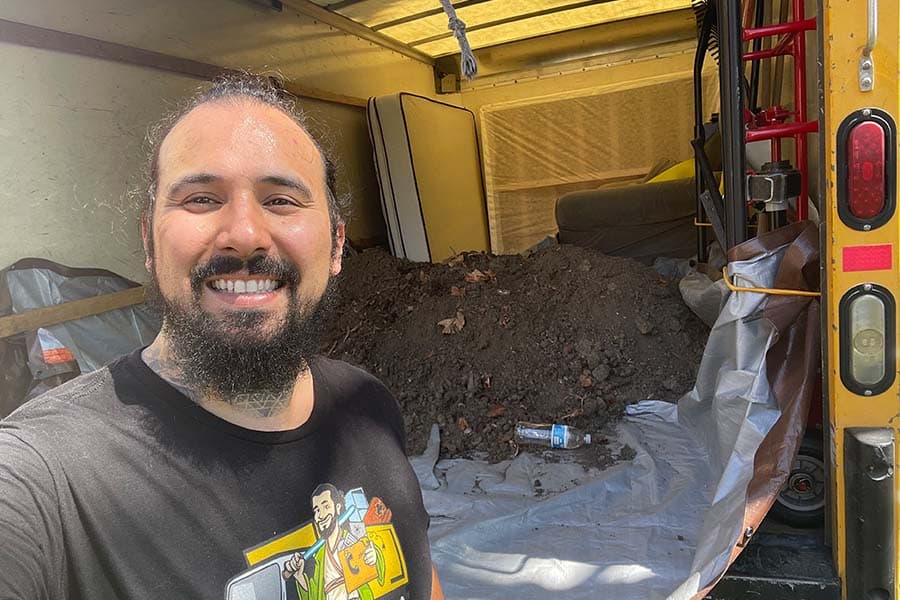 Andrew Thompson smiling during a Jedi Junk Removal job