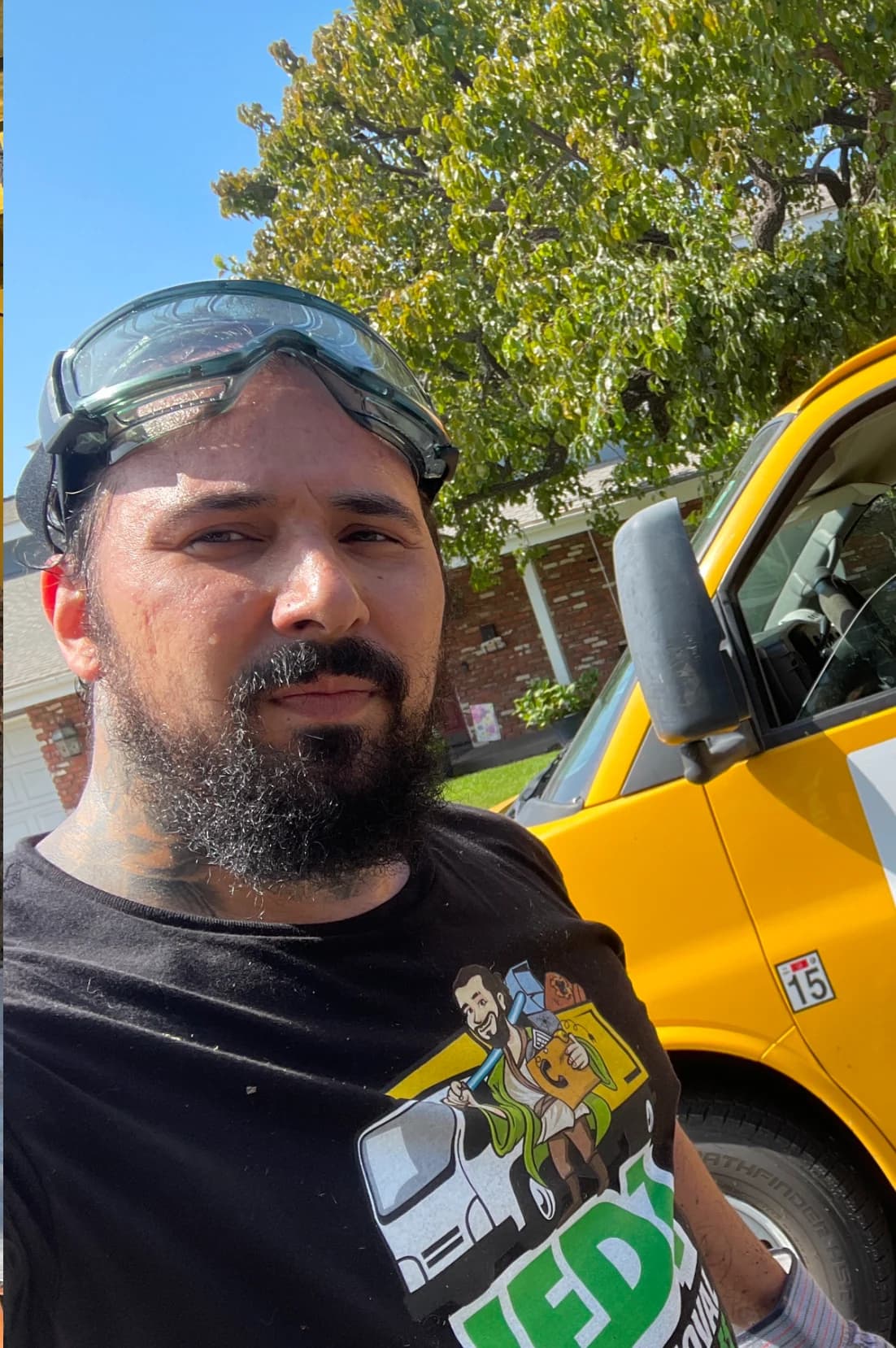 Andrew Thompson on a Jedi Junk Removal job beside a work truck