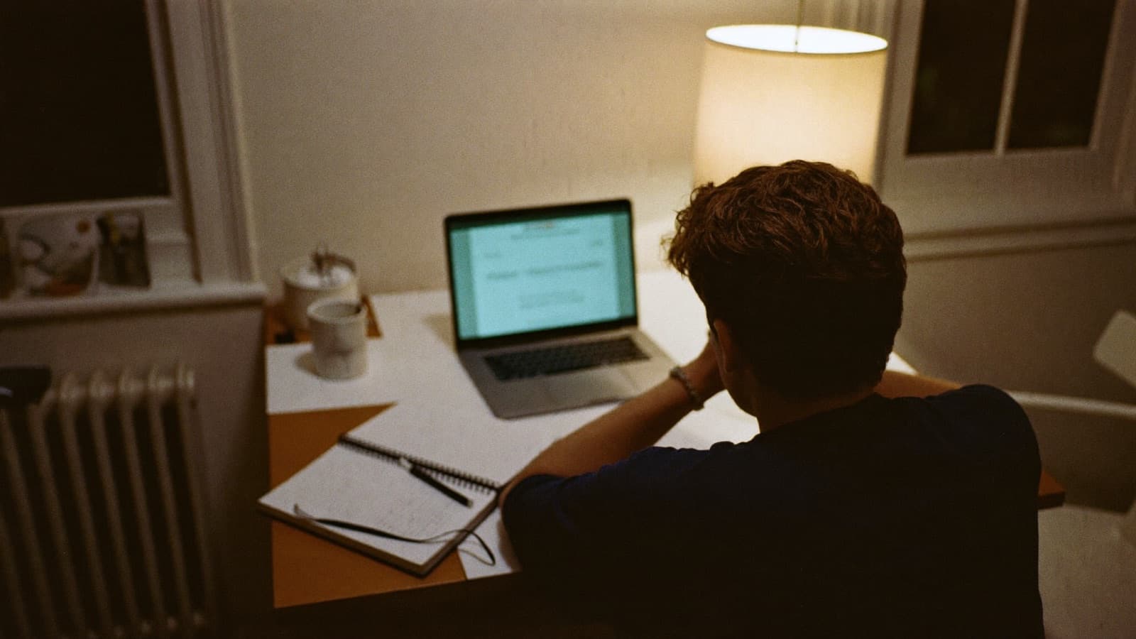 Junk removal owner watching an online business course on a laptop in his truck
