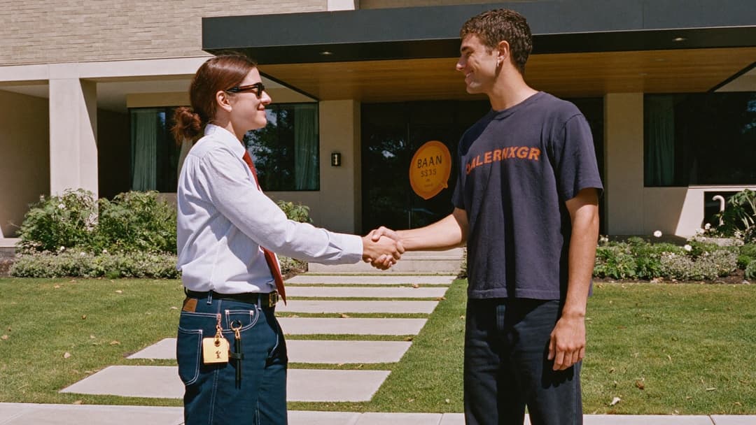 Junk removal owner shaking hands with a property manager outside an apartment complex office