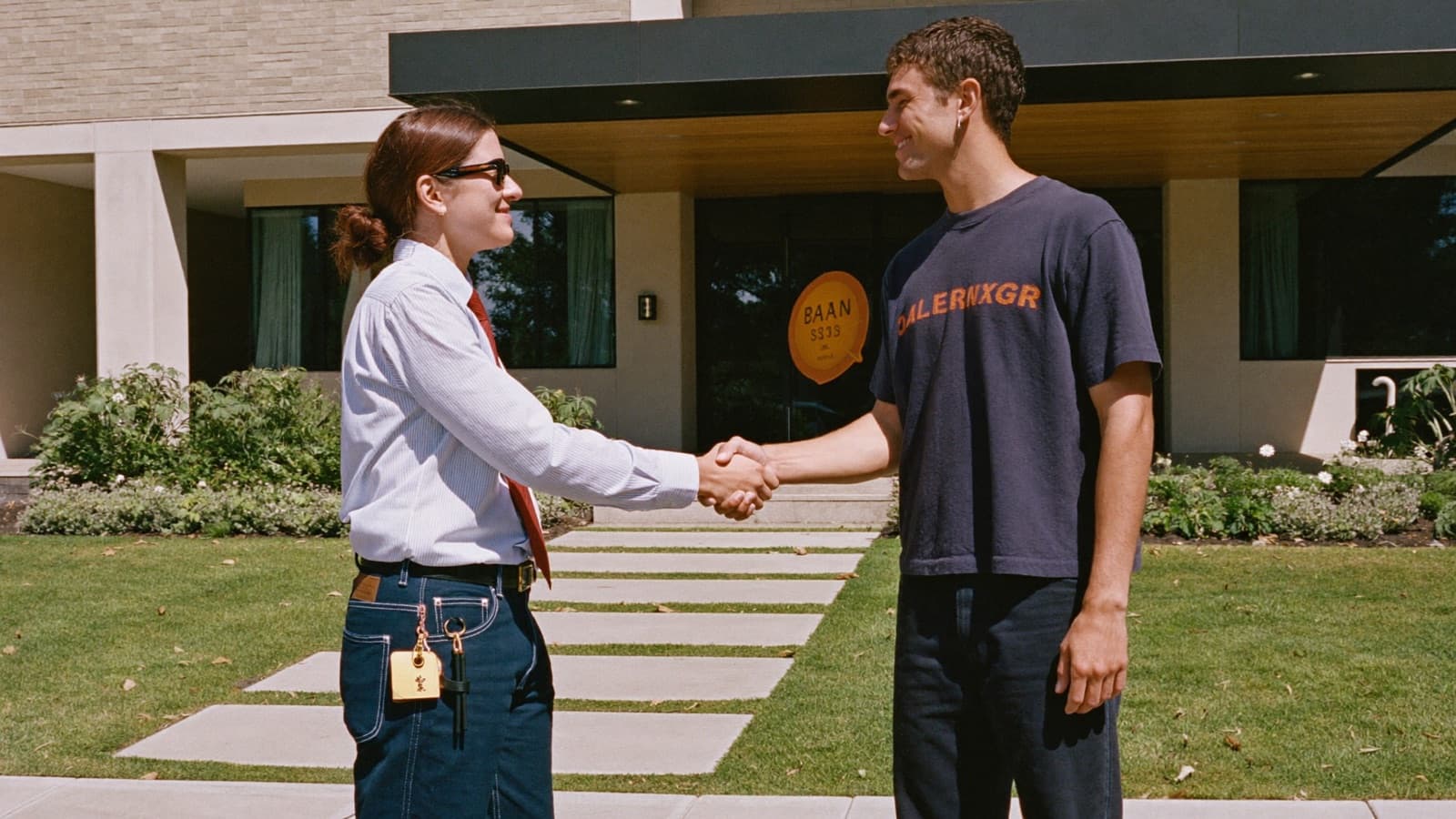 Junk removal owner shaking hands with a property manager outside an apartment complex office