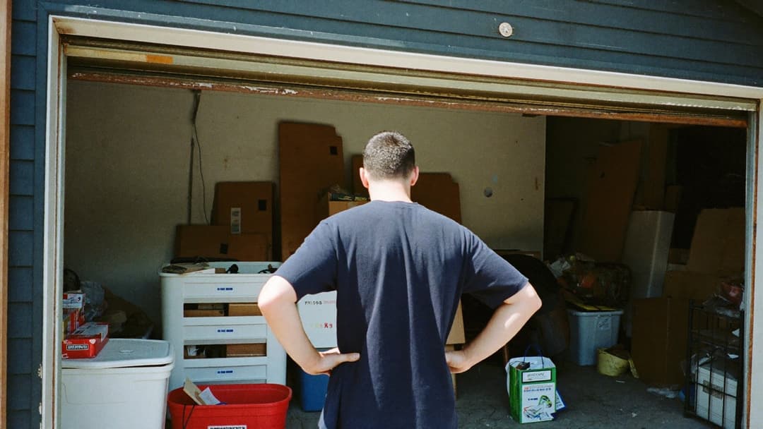 Operator holding a laminated pricing sheet on a clipboard beside a loaded truck