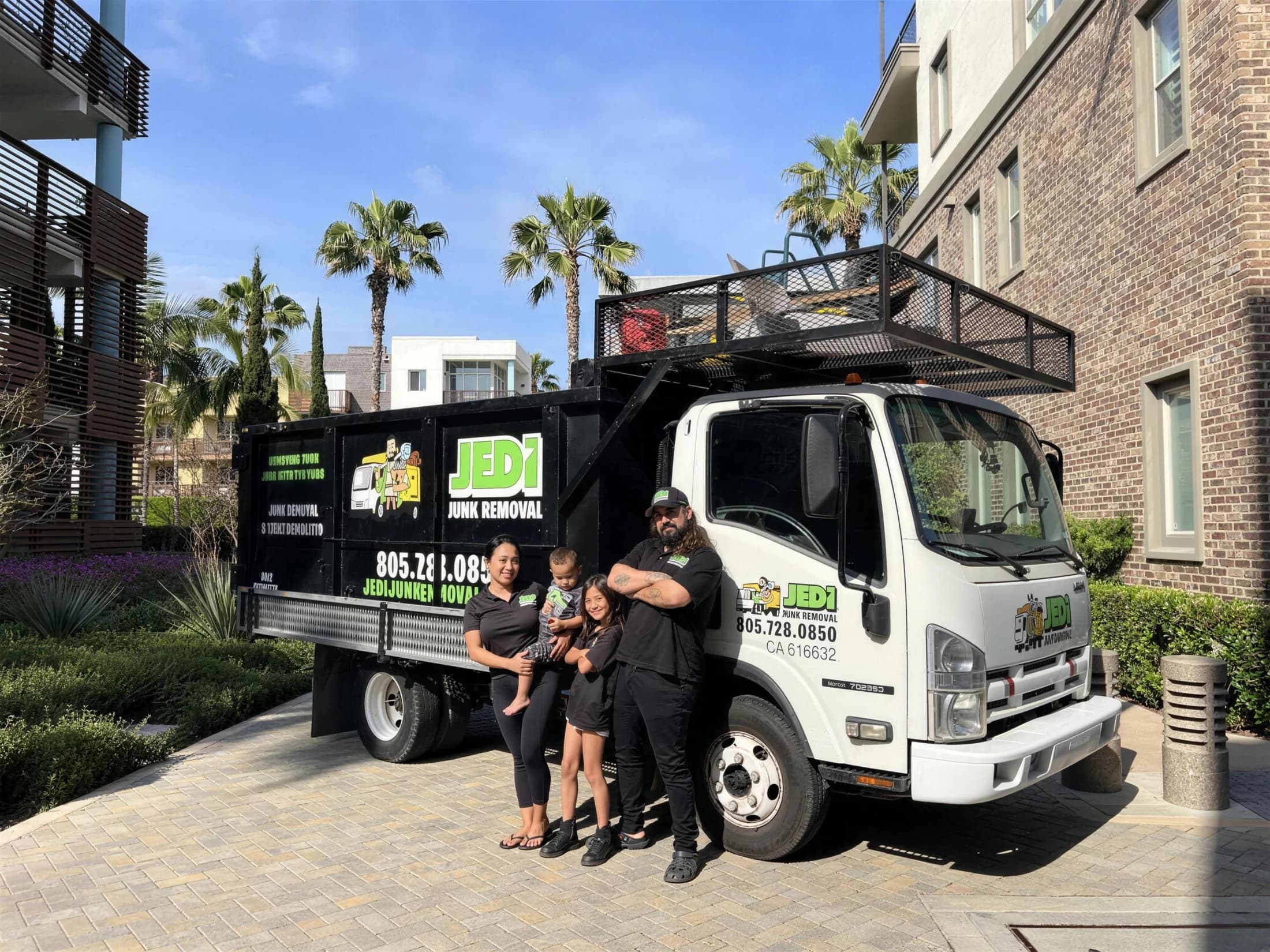 Me and my family standing in front of a JEDI Junk Removal truck