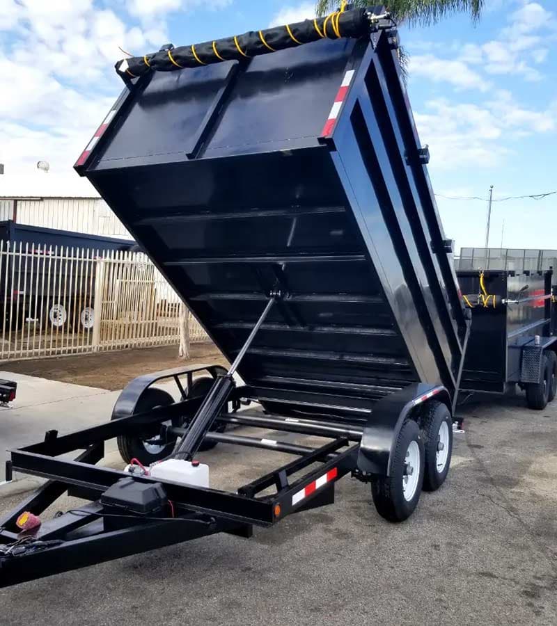 The black $10,000 dump trailer with its hydraulic bed raised