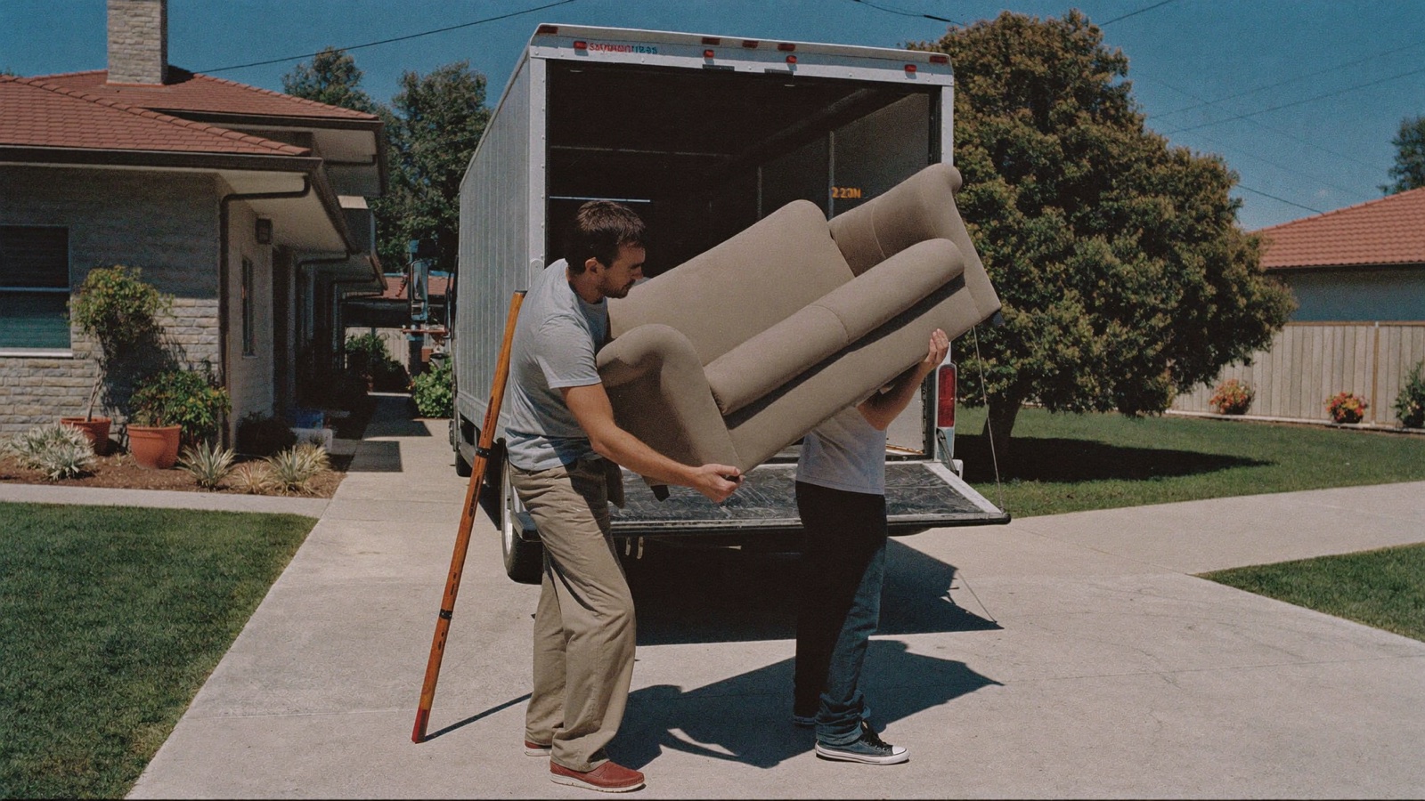 New junk removal hire on a paid training day loading a mattress with the crew