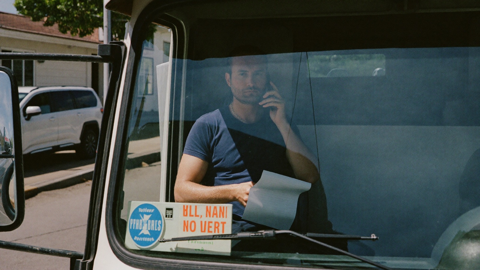 Phone operator explaining truck volume pricing with a pricing sheet beside the keyboard